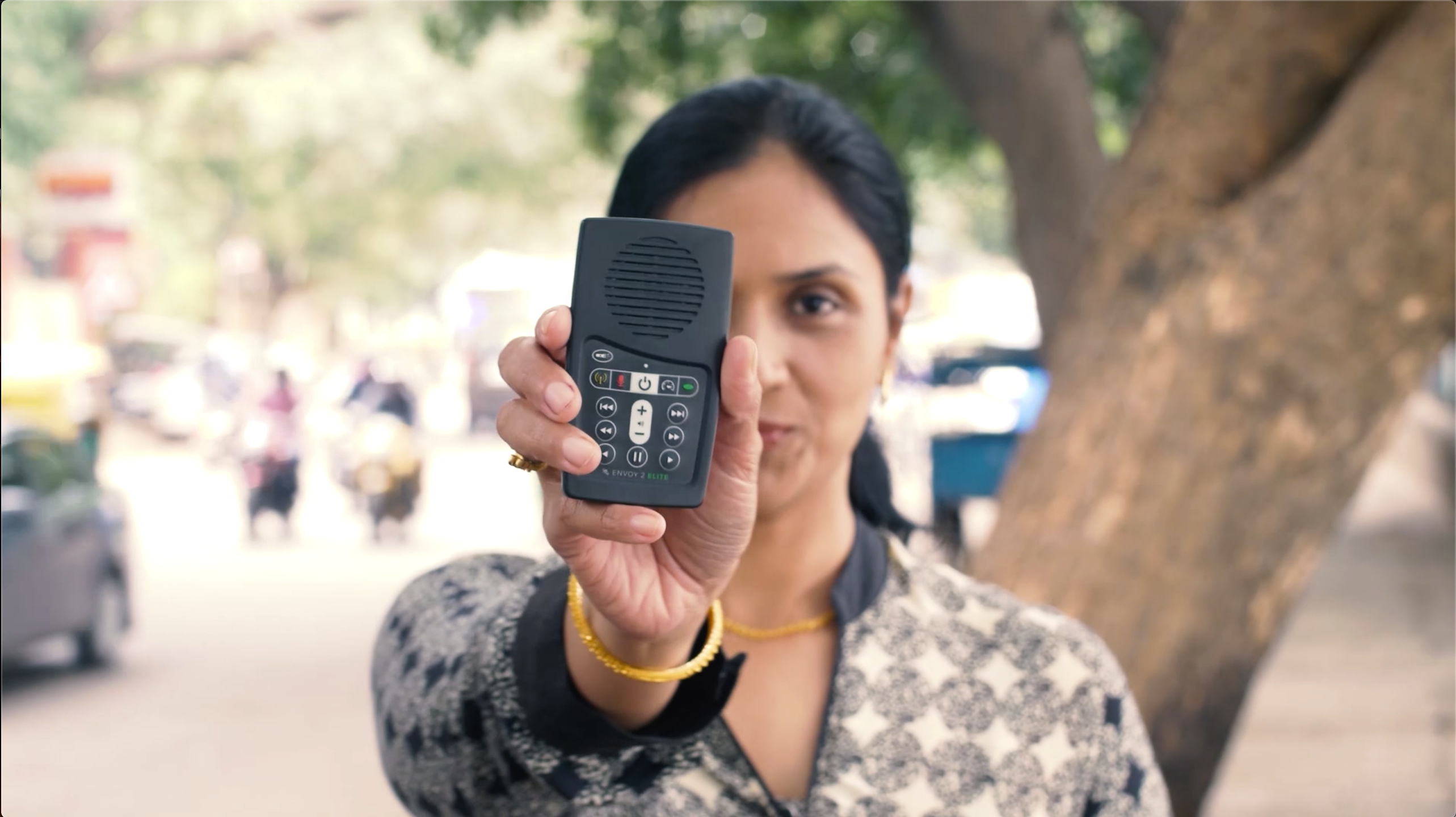 Indian woman studies while commuting using MegaVoice Envoy 2 S Dual and accredited online Bible colleges